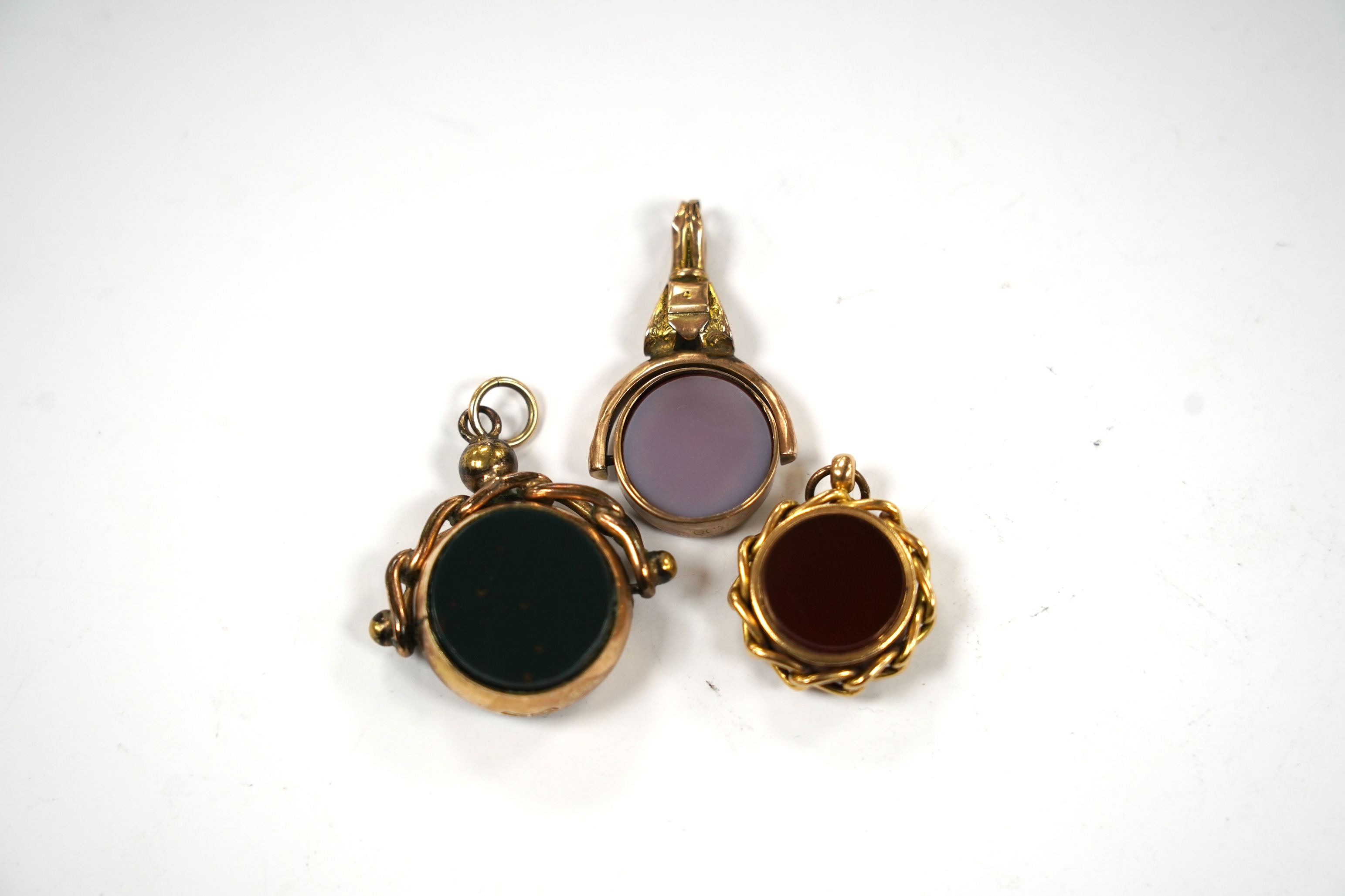 Three late Victorian carnelian set fob seals including 18ct rolled gold, largest 3mm.